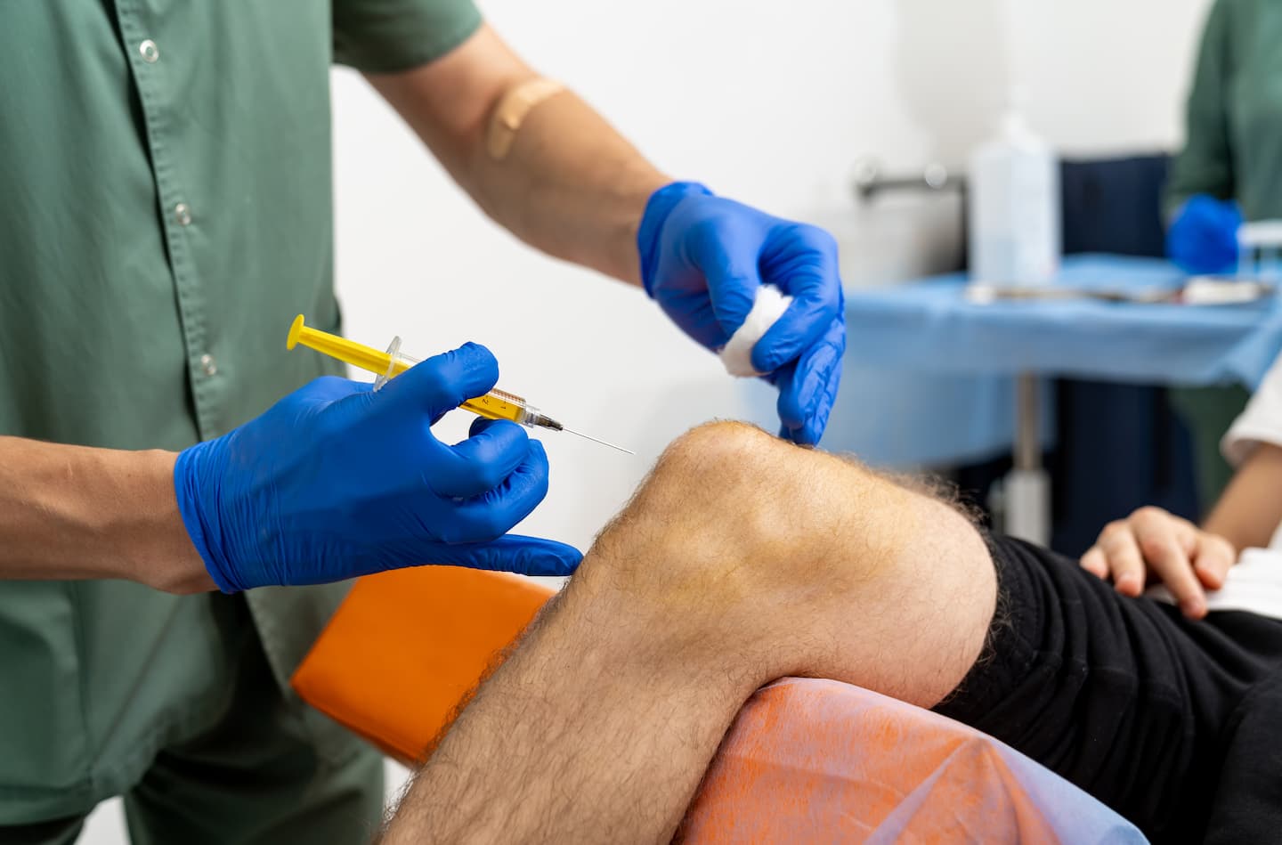 knee medical injection doctor hand holding syringe injection knee 1