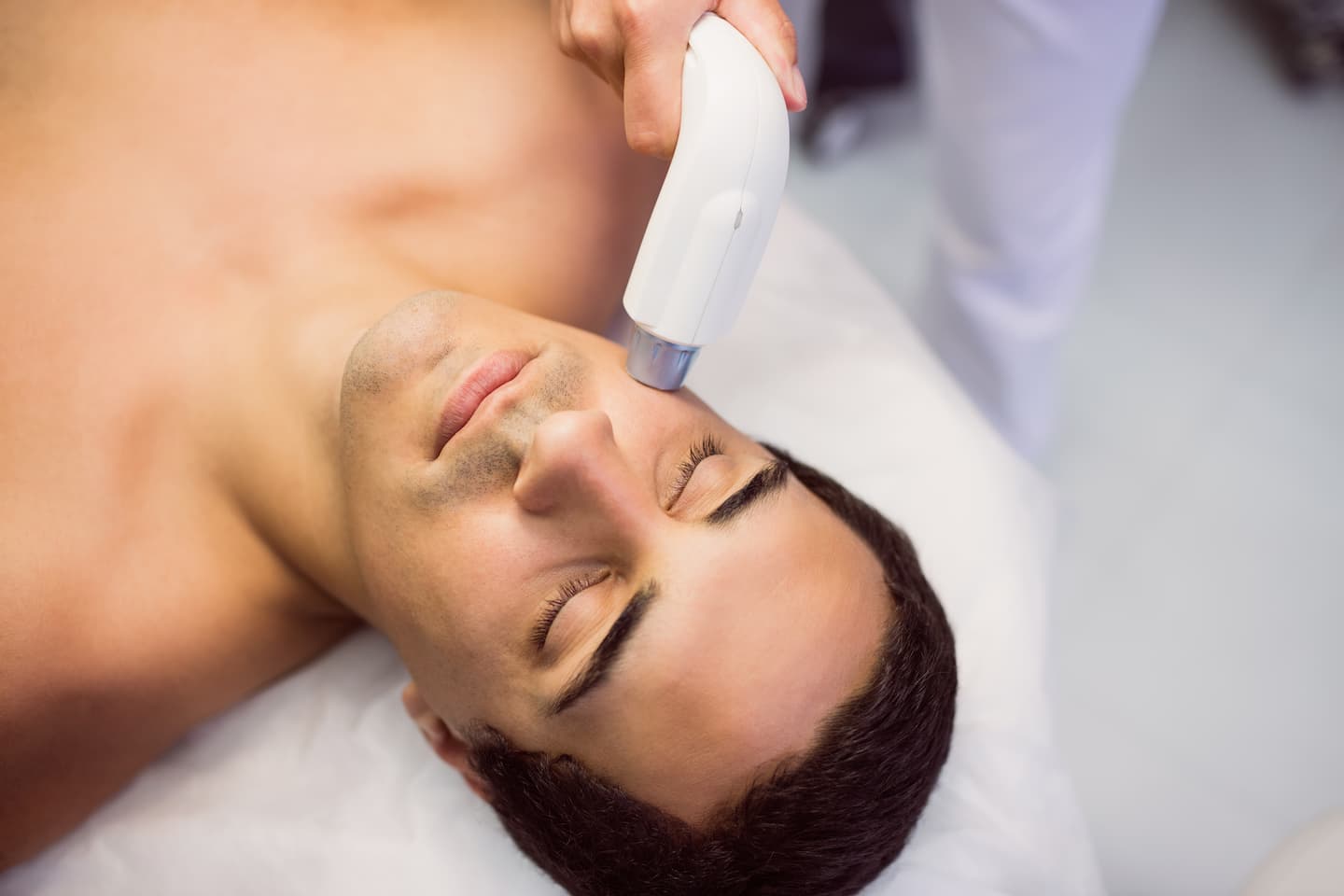 man getting facial massage clinic 1