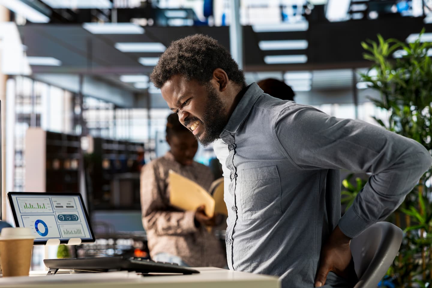 african american business analyst deals with back pain muscle cramps 1 Interventional Interventional,Regenerative pain therapy,Pain Solutions,Chronic pain relief,Non-surgical pain treatments Airport Plaza Spine and Wellness